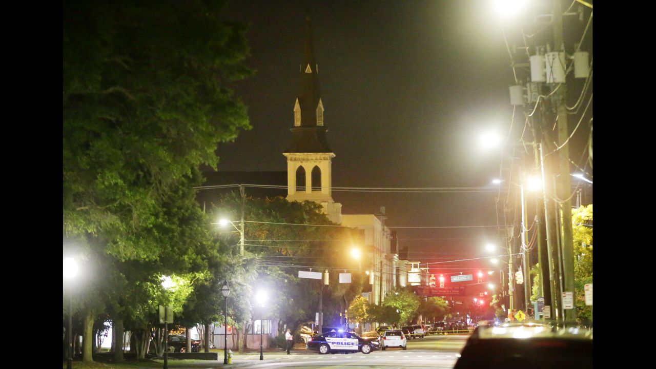 Police in Charleston close off a section of Calhoun Street early on June 18, after the shooting. The steeple of the church is visible in the background.