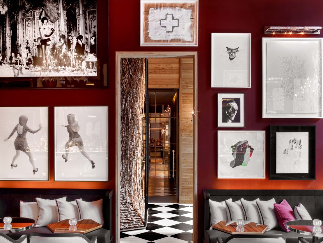 Photographs and work on paper distract visitors from the Baccarat bar's dazzling chandeliers.