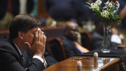 South Carolina state Sen. Vincent Sheheen gets emotional on June 18 as he sits next to the draped desk of Sen. Clementa Pinckney at the statehouse in Columbia, South Carolina. Pinckney was one of the nine people killed in the church shooting.