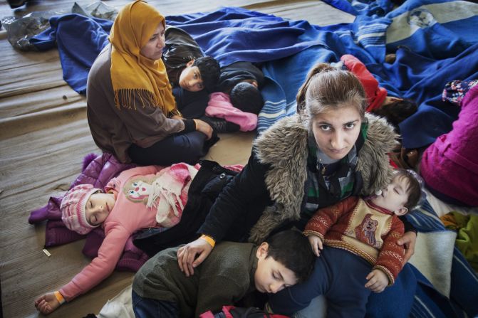 A Syrian refugee mother comforts her children, after being rescued from a fishing boat carrying 219 people who had hoped to reach Europe. They are among the millions uprooted by war.