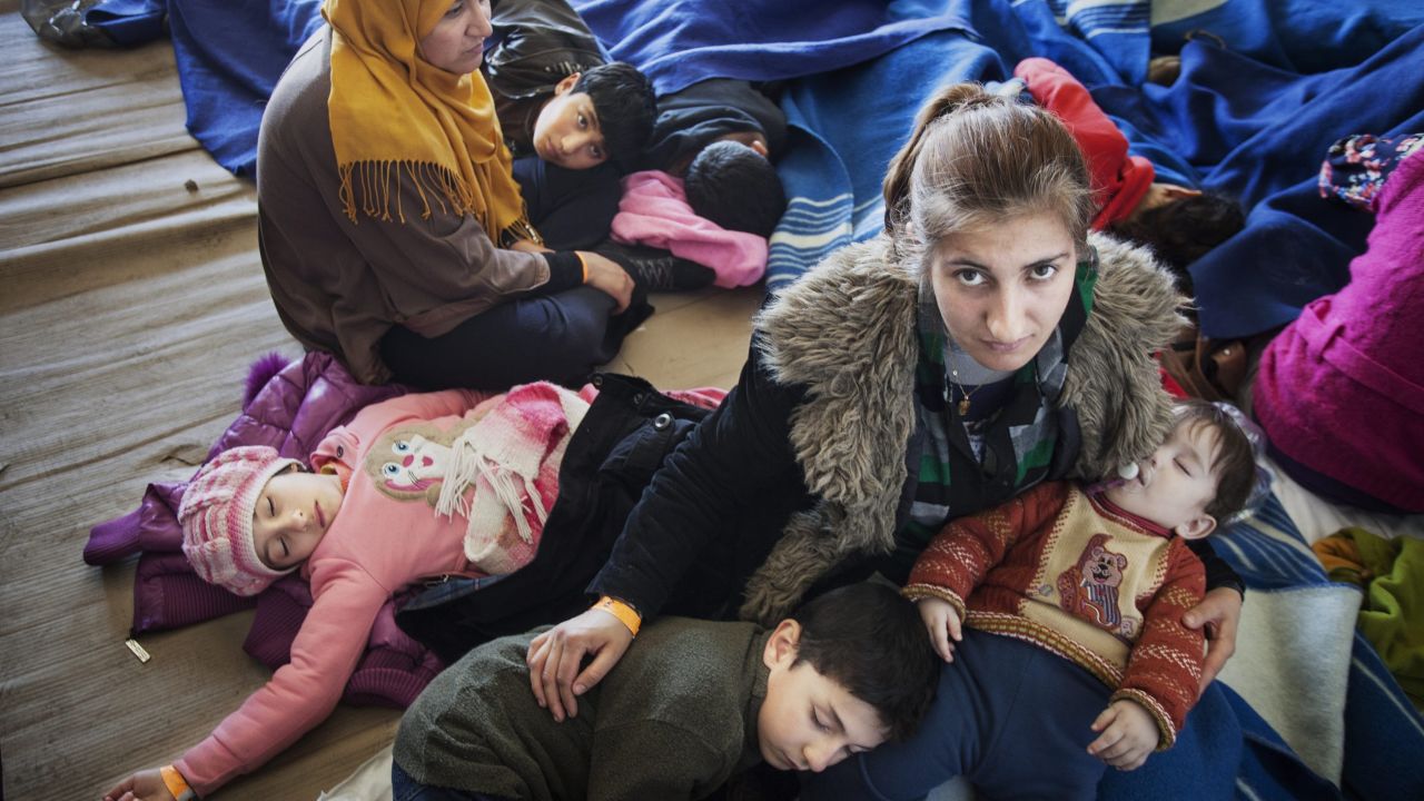 A Syrian refugee mother comforts her children, after being rescued from a fishing boat carrying 219 people.