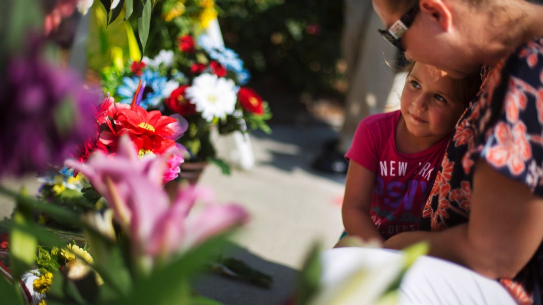 Kim Hamby prays with her daughter Kayla as they lay flowers at a makeshift memorial in Charleston on June 18.