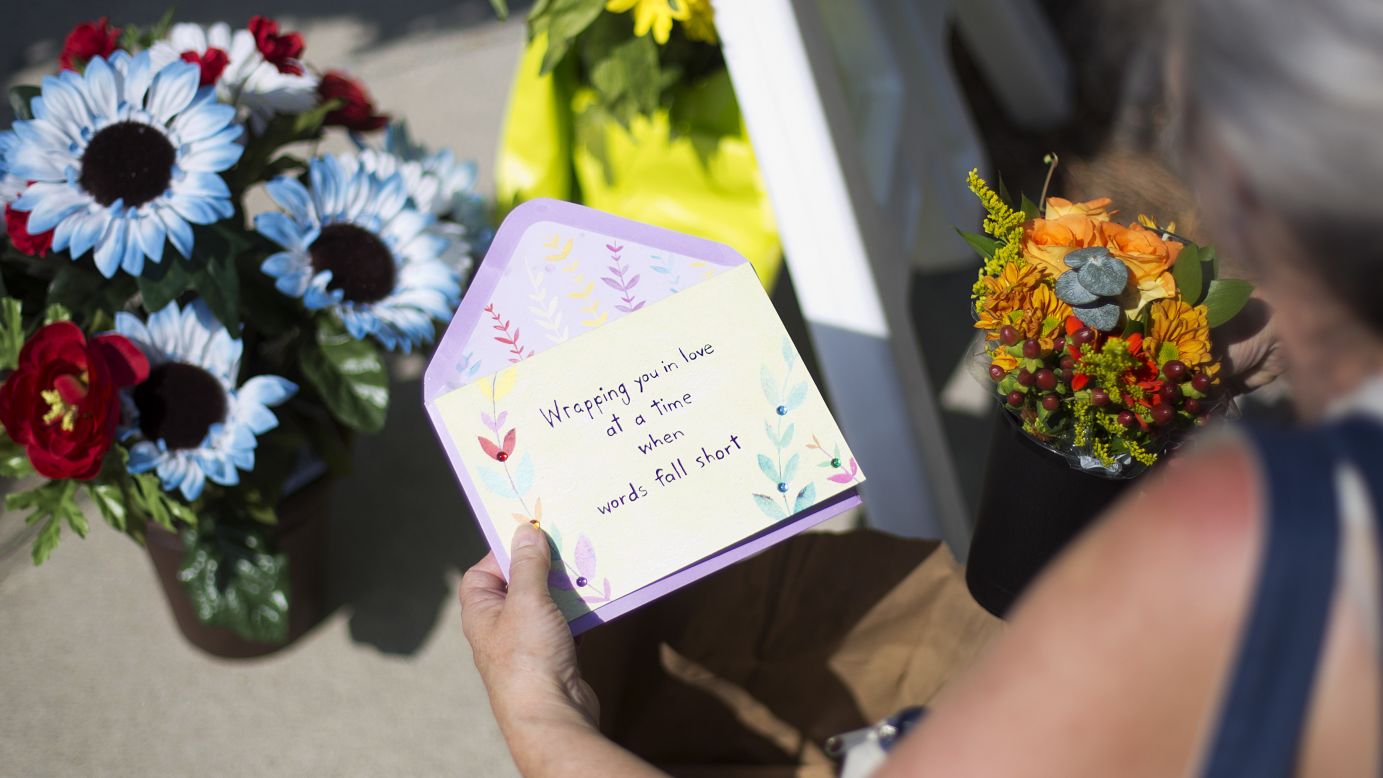 Sandra Bridges lays a card at a memorial on June 18.