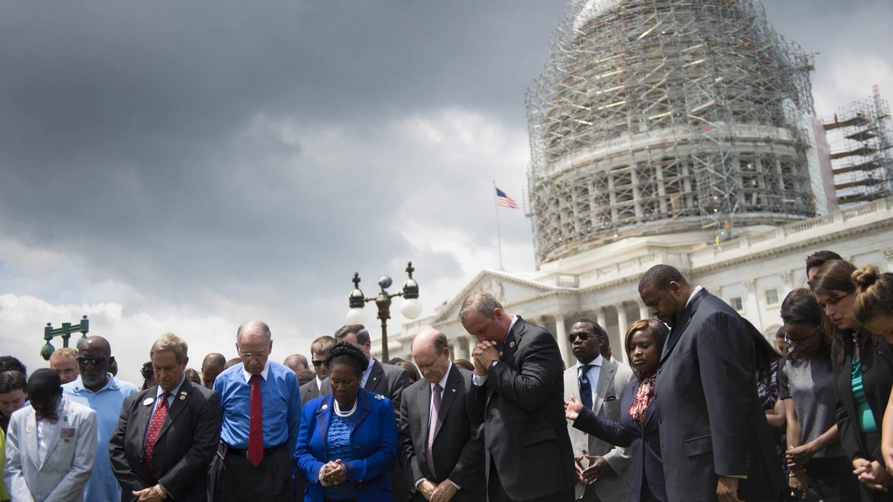 Members of the U.S. Congress gather in front of the Capitol Building in Washington on June 18, during a moment of silence for the nine killed in a church shooting in Charleston, South Carolina.