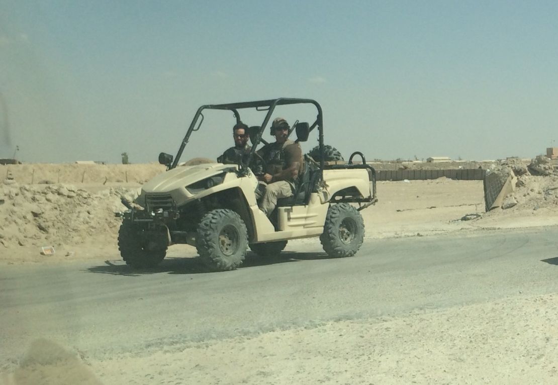 American advisers watch proceedings from a golf cart.