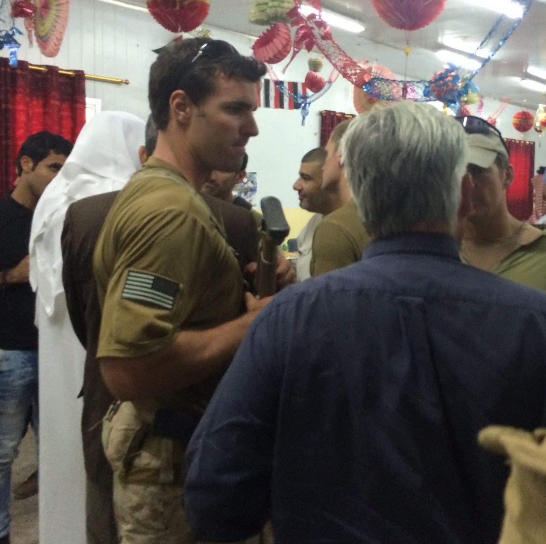 U.S. advisers talk to CNN's Ben Wedeman at a reception after the graduation ceremony.