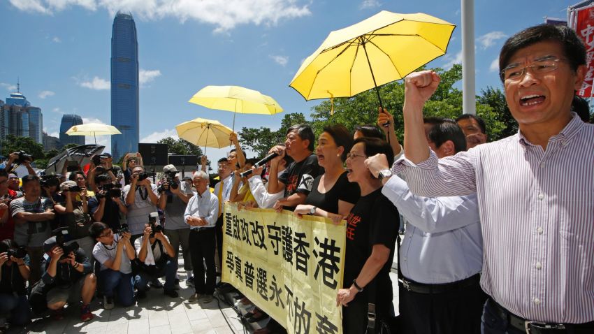 Pro-democracy lawmakers celebrate outside the Legislative Council in Hong Kong on June 18, 2015 after defeating a controversial Beijing-backed reform electoral reform bill.