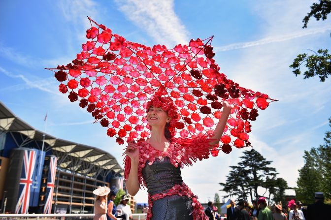 "The ladies go to a hell of a lot of effort on Ladies' Day," says horse racing journalist Oliver Brett, who attempted to seek shade under this fantastically large creation.