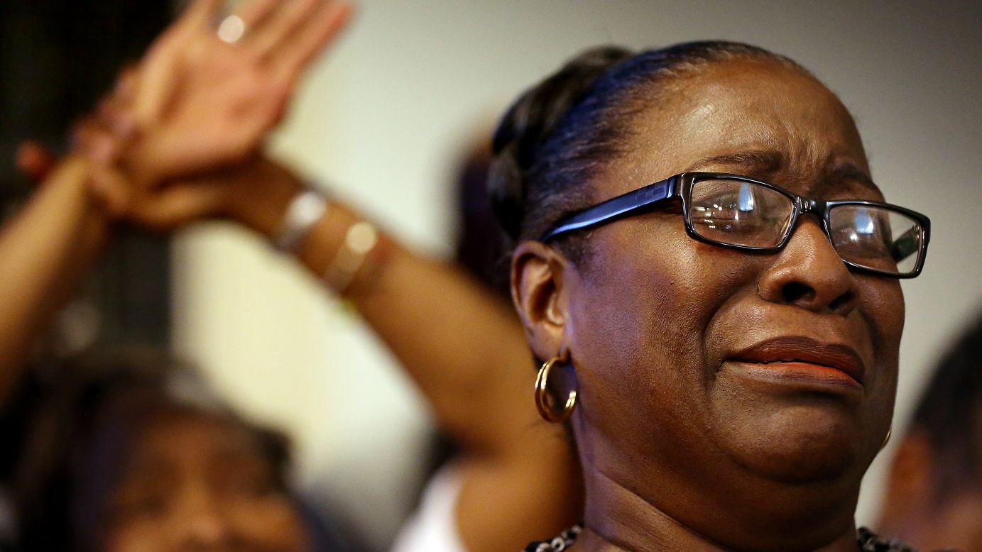 The Rev. Jeannie Smalls becomes emotional during a prayer vigil held at Morris Brown AME Church on June 18.