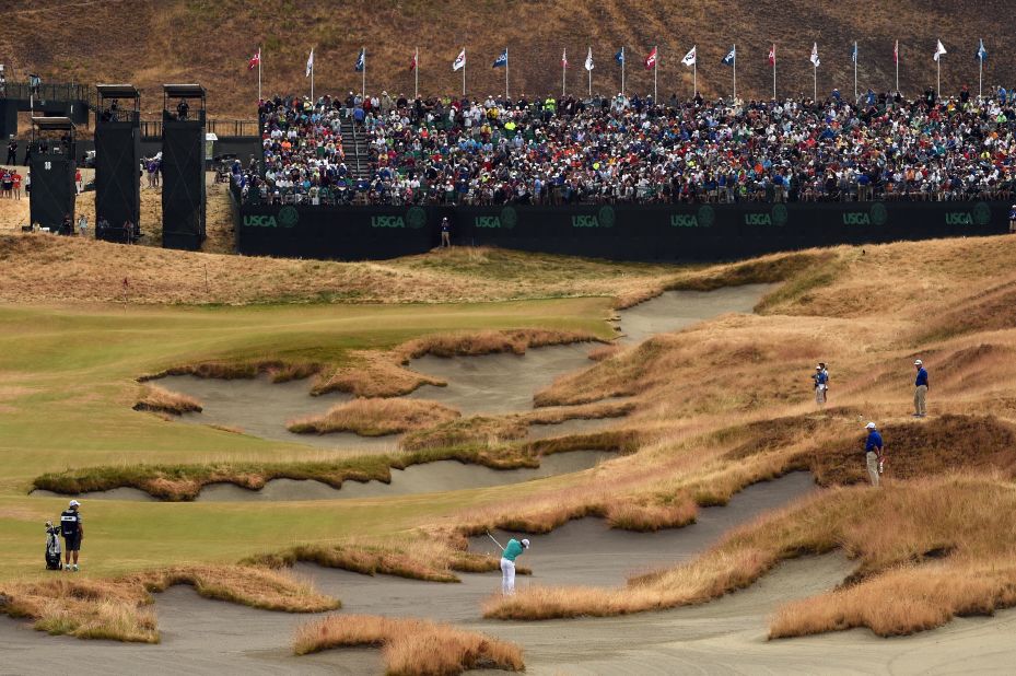 Rory McIlroy plays out of the bunker on the 18th hole at the Chambers Bay course. The Northern Irishman would finish the day with a two-over-par 72.
