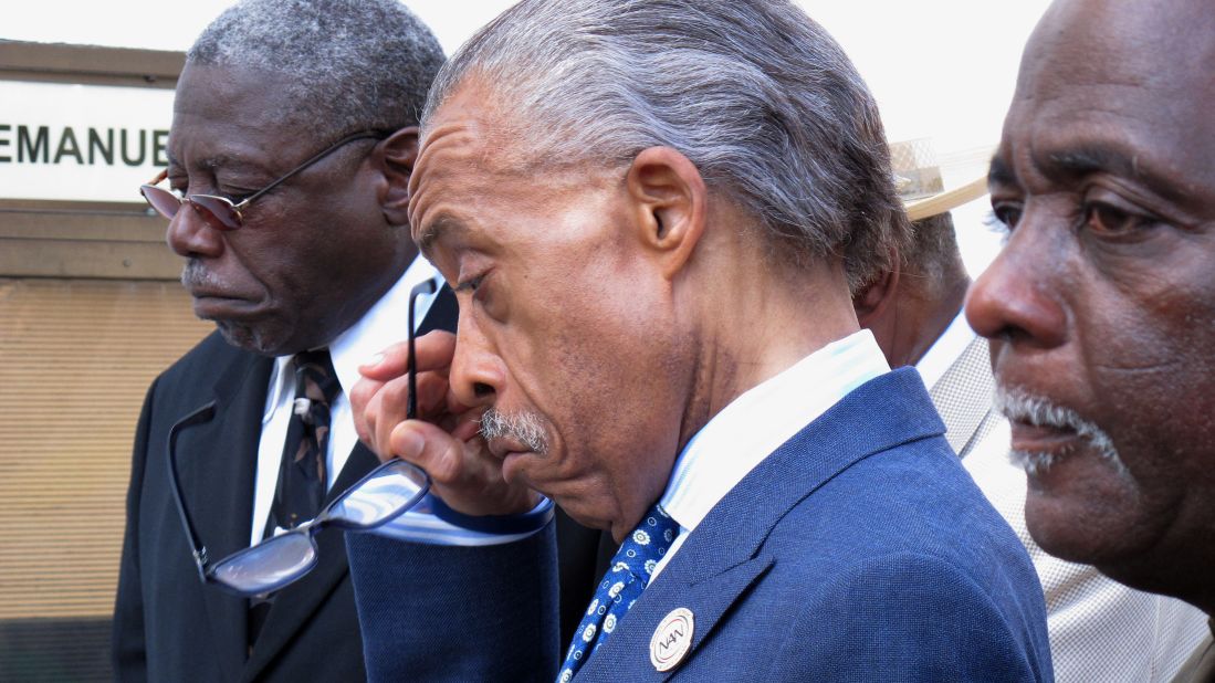 The Rev. Al Sharpton wipes away a tear after praying outside the Emanuel  AME Church in Charleston on June 18. 