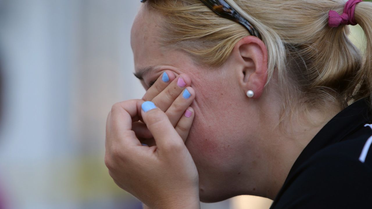 A woman wipes her eyes at a makeshift memorial near the Emanuel AME Church in Charleston on June 18.