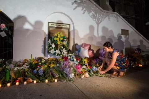 A woman places flowers outside the church on June 18.