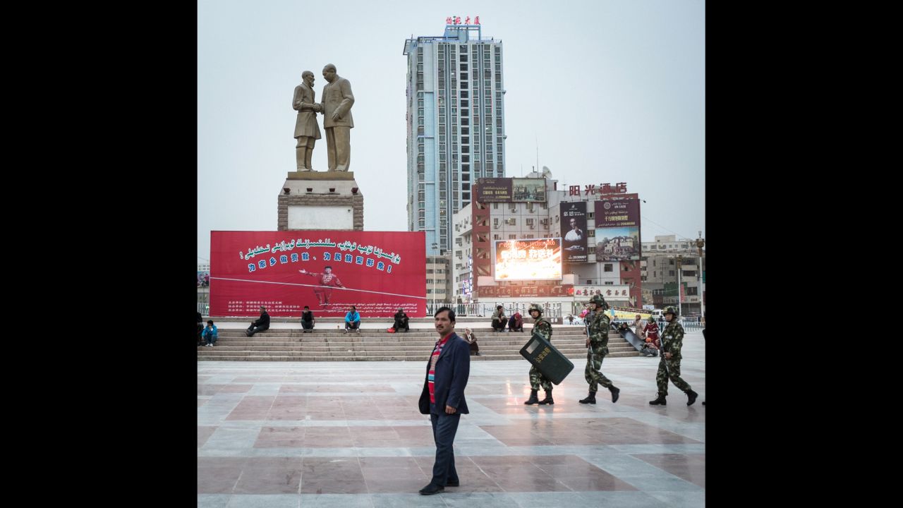 A Uyghur man stands on the main square in Hotan, China. The province was contested among Mongols and Turkic groups before coming under Chinese rule in the 18th century. Recently, the Turkic-speaking Uyghurs of the province have protested Chinese rule as they become a minority group to the immigrating Han Chinese.