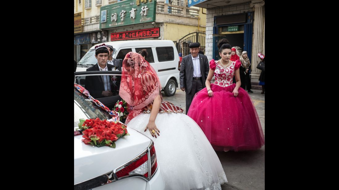 A Uyghur bride boards a car in Korla, China.