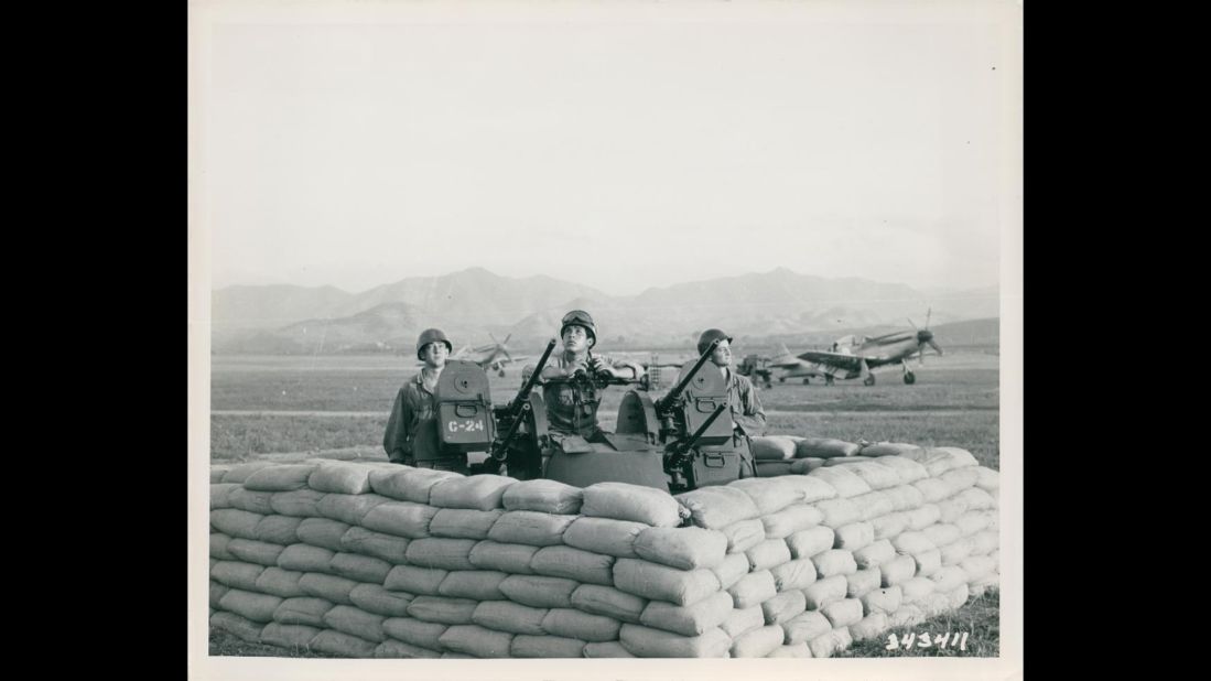 A U.S. gun crew keeps a sharp lookout for enemy planes at an airstrip somewhere in Korea in July 1950. Photo ID: SC 343411 