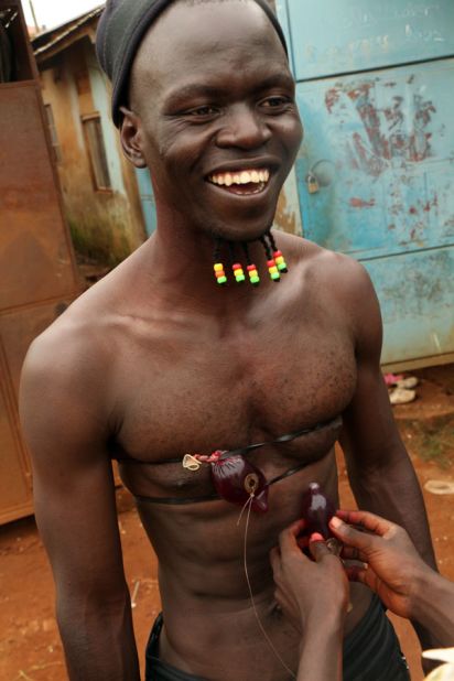 Free condoms, sourced from the local health clinic, are used as props to dispense blood.