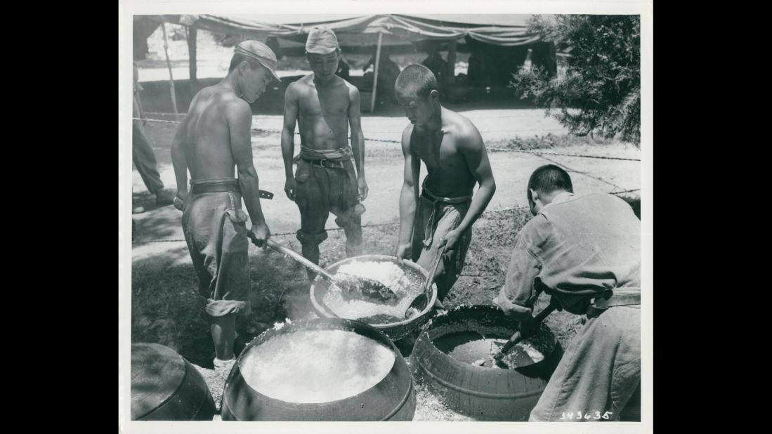 South Korean combat troops prepare a meal in July 1950. Photo ID: SC 343635