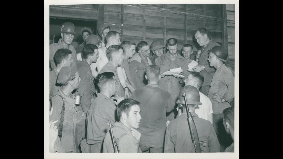 Unidentified soldiers of the 13th Signal Company, 1st Cavalry Division hope for a package or letter from home during mail call in July 1950. Photo ID: SC 344600 