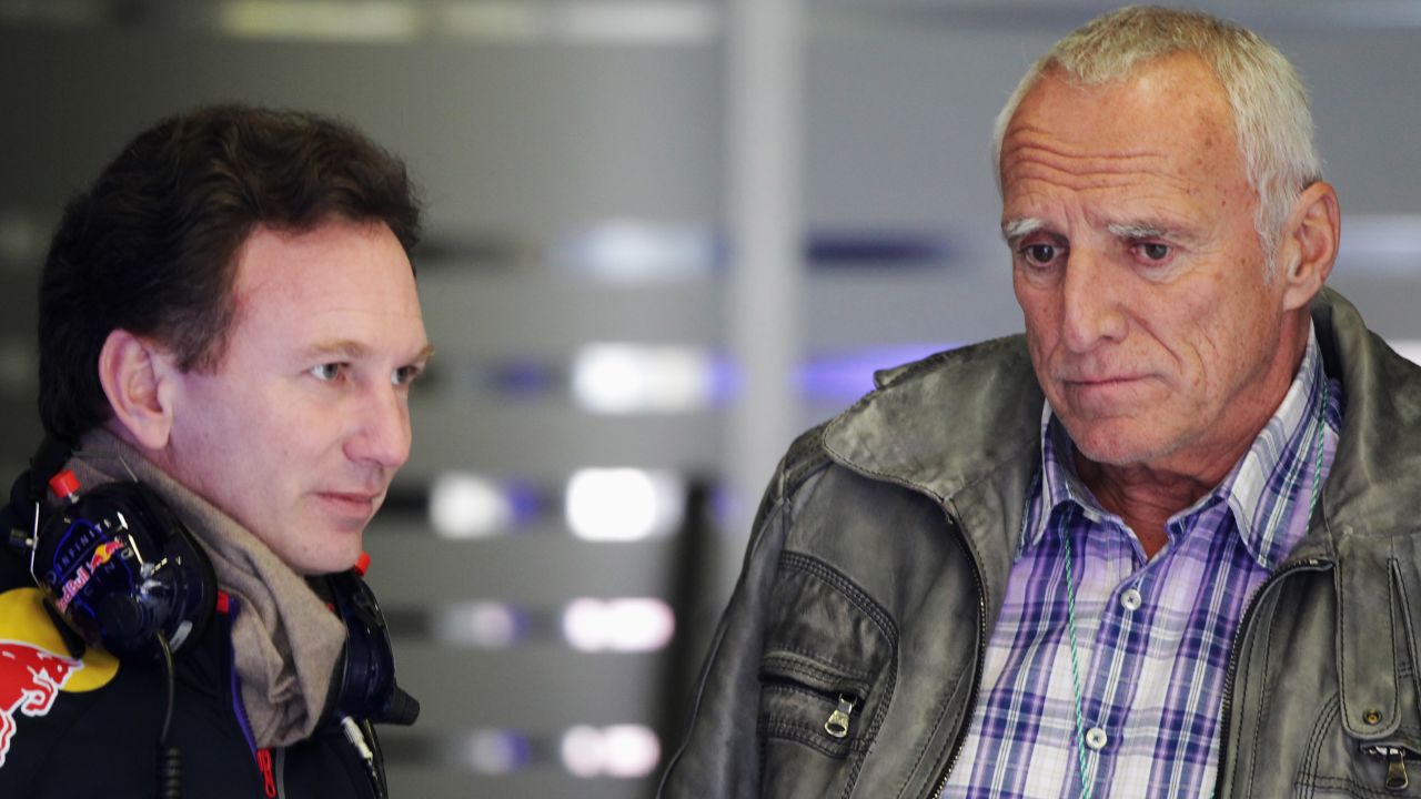 Mateschitz (R) talks with Christian Horner (L) during day three of winter in Spain in 2014.