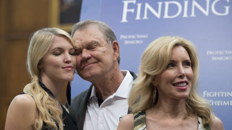 Campbell hugs his daughter Ashley, left, as they attend a 2012 news conference with US Sen. Edward Markey, co-chairman of the Congressional Task Force on Alzheimer's Disease. The Campbell family has advocated for awareness and research on the disease.