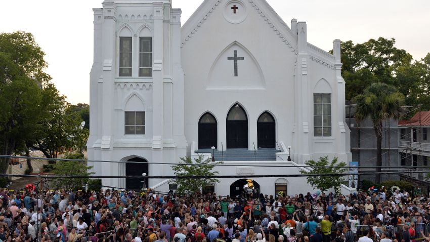 People que to lay flowers at Emanuel AME Church in Charleston, South Carolina on June 19, 2015. Police captured the white suspect in a gun massacre at one of the oldest black churches in the United States, the latest deadly assault to feed simmering racial tensions. Police detained 21-year-old Dylann Roof, shown wearing the flags of defunct white supremacist regimes in pictures taken from social media, after nine churchgoers were shot dead during bible study on June 17. AFP PHOTO/MLADEN ANTONOV        (Photo credit should read MLADEN ANTONOV/AFP/Getty Images)