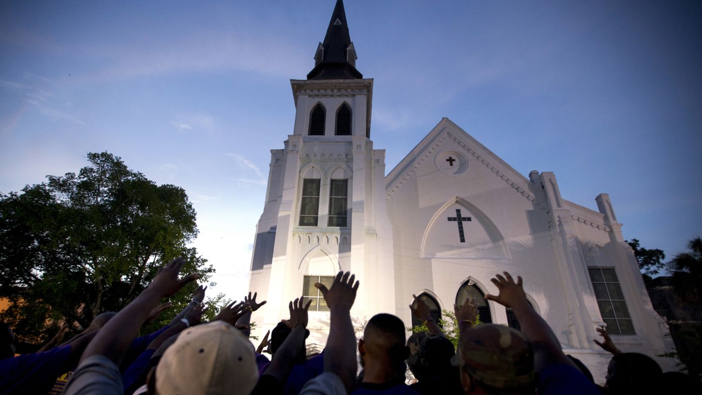 The men of Omega Psi Phi Fraternity lead a prayer outside Emanuel AME Church, Friday, June 19.