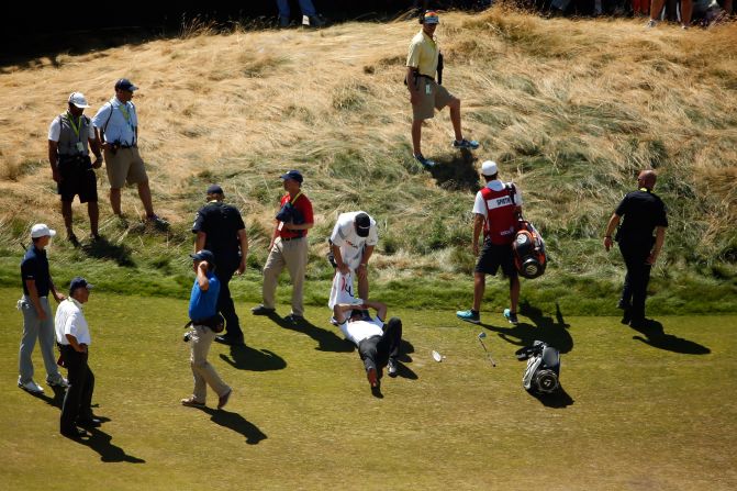 Australia's Day fell to the turf on the ninth fairway as he completed his second round and had to be attended by paramedics before bravely completing his round of 70.