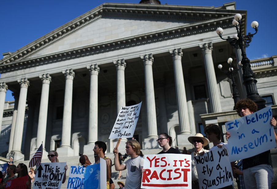 Protesters stand on the South Carolina State House steps during a rally to take down the Confederate flag, on Saturday, June 20, in Columbia. 