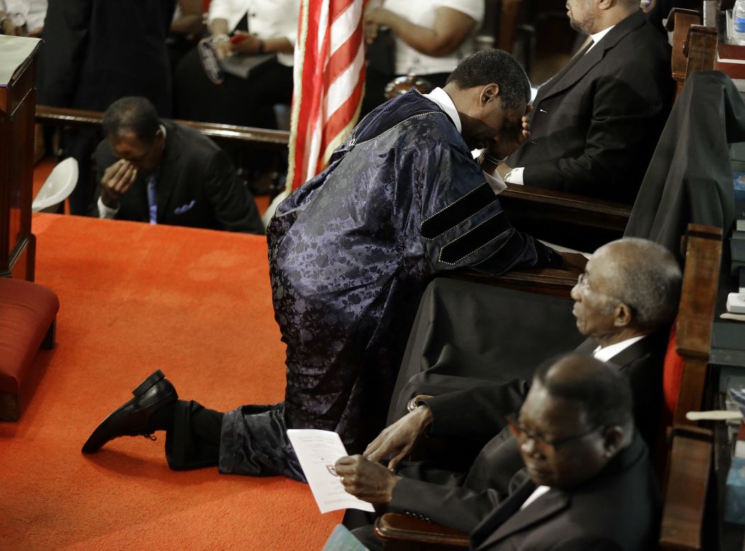 The Rev. Norvel Goff prays at the empty seat of the Rev. Clementa Pinckney, who was killed in the shooting. 