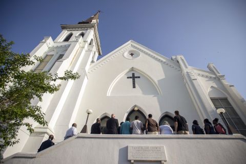 People line up to enter the Emanuel African Methodist Episcopal Church in Charleston, South Carolina, before a worship service on Sunday, June 21. It was the first service at the church since a racially motivated shooter killed nine people there on Wednesday, June 17.