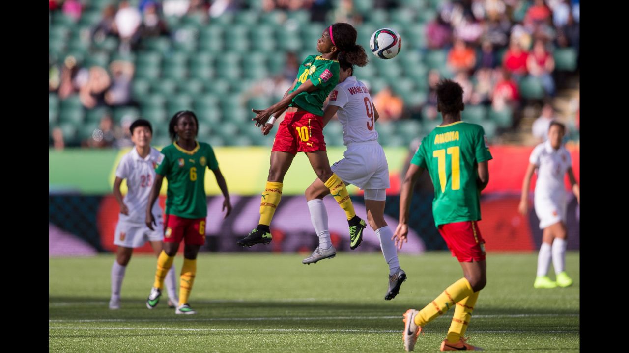 Cameroon's Jeannette Yango and China's Wang Shanshan compete for a header. 