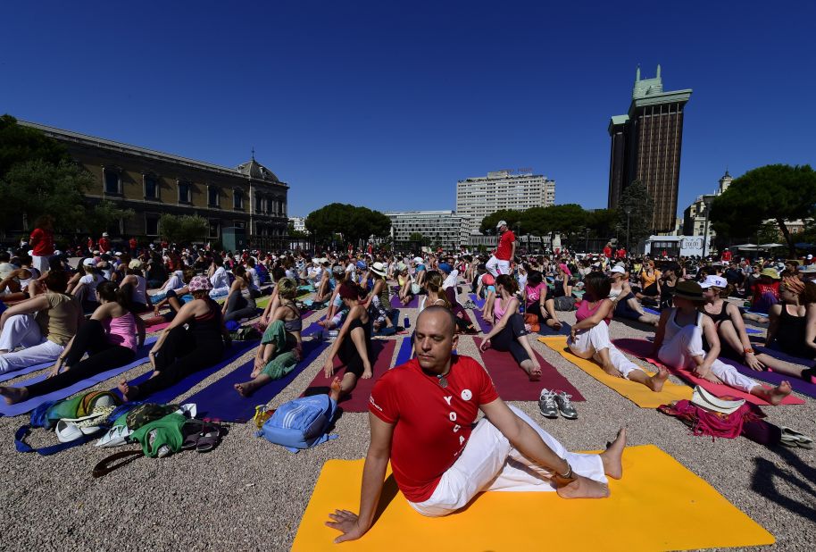 Events similar to the one held in New Delhi were held around the world.  Here participants take part in a mass yoga session at Colon square in Madrid. 