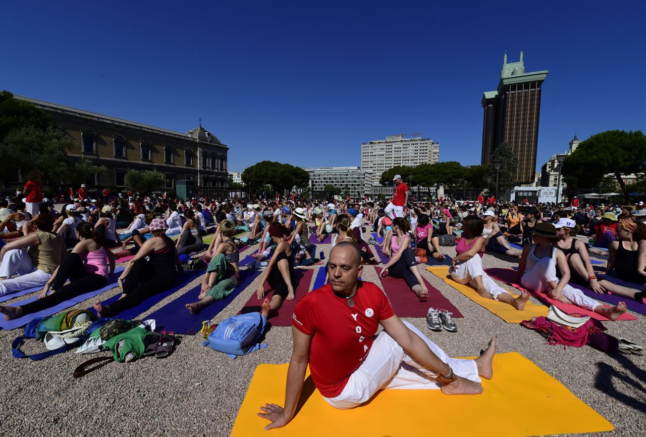 Participants take part in a mass yoga session at Colon square in Madrid for International Yoga Day in June 2015. 