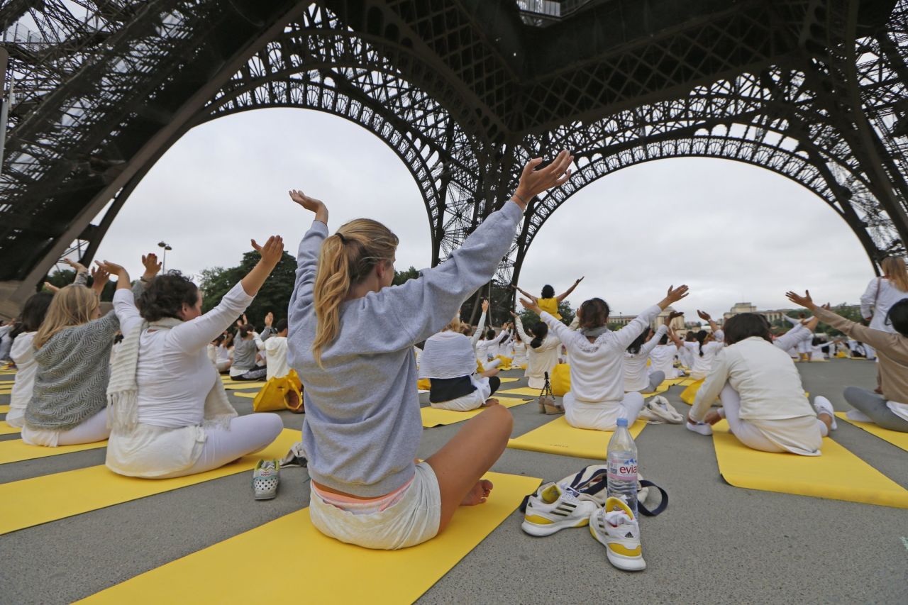 Hundreds of yoga devotees gather under the Eiffel Tower in Paris. 