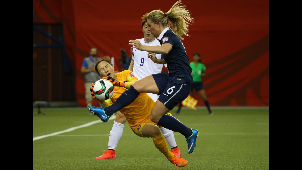 South Korean goalkeeper Kim Jung-mi makes a save against France's Amandine Henry during the first half.