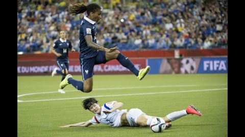 French midfielder Elodie Thomis leaps over South Korea defender Lee Eun-mi.