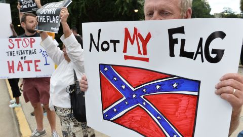 A man holds a sign up during a protest rally against the Confederate flag in Columbia, South Carolina on June 20, 2015. 