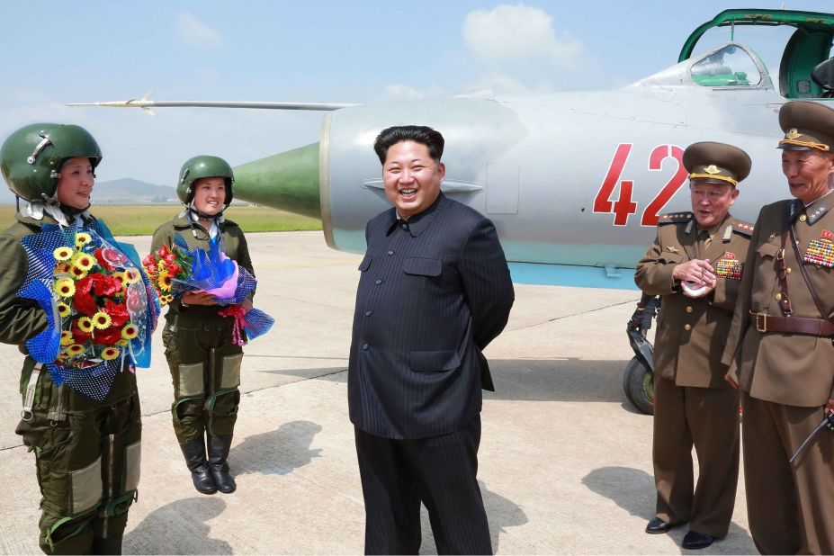 North Korean leader Kim Jong Un meets with North Korea's first female fighter jet pilots in this undated photo released by the country's state media on Monday, June 22. He called the women "heroes of Korea" and "flowers of the sky."