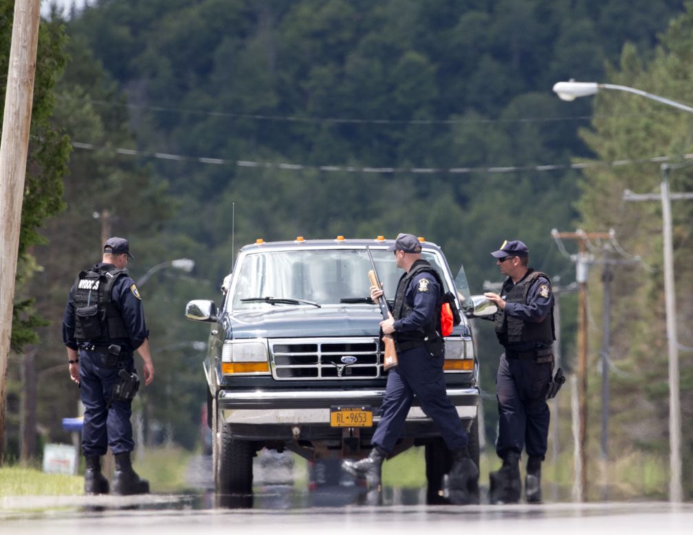 Corrections officers stop a vehicle Monday, June 22, in Owls Head, about 20 to 25 miles west of the prison where Matt and Sweat escaped. The discovery of the escapees' DNA in a cabin re-energized the search for the fugitives.
