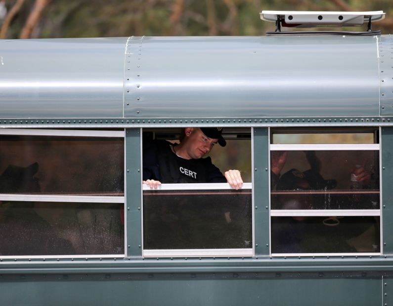 A bus transports corrections officers to a search area in Mountain View, New York, on June 22.