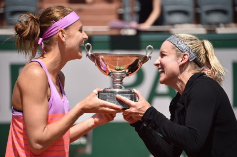 Mattek-Sands (R) celebrates her 2015 French Open title with doubles partner Lucie Safarova. The American is accompanied on the road with her husband, Justin Sands, as well as her coach Adam Altschuler and his girlfriend Brenda, who helps with travel coordination. 