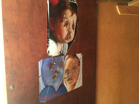 The eyes are scratched off of the pictures of little kids in a closet inside a former ISIS base.