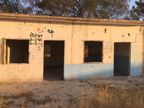 Target practice: Crosshairs are spray-painted on the walls of a former ISIS base near Mabrouka. 