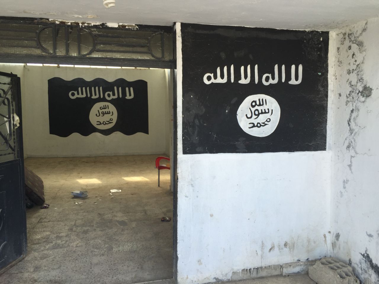 An ISIS security office in Tal Abyad, featuring the feared and hated ISIS flag painted on the walls. 