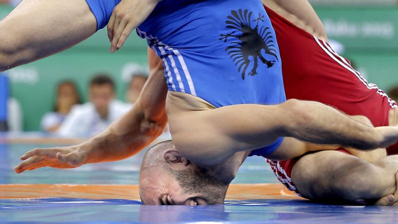 Islam Islamaj of Albania face plants while wrestling Alexandru Chirtoaca of Moldova in the men's freestyle 57-kilogram bronze match wrestling at the Baku 2015 European Games on Wednesday, June 17.