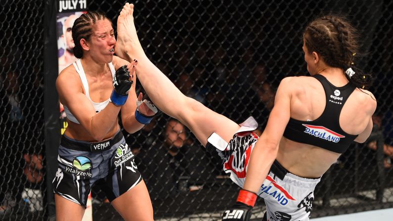 Joanna Jedrzejczyk of Poland lands a front kick against Jessica Penne of the United States in their women's strawweight championship bout during the UFC Fight Night event on Saturday, June 20, in Berlin. 