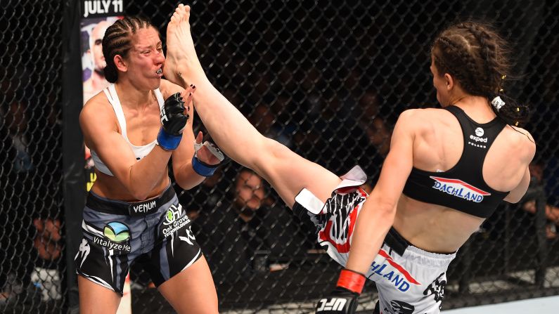 Joanna Jedrzejczyk of Poland lands a front kick against Jessica Penne of the United States in their women's strawweight championship bout during the UFC Fight Night event on Saturday, June 20, in Berlin.