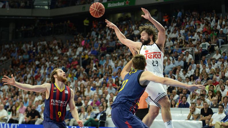 Players from RealMadrid and FCBarcelona vie for the ball during the first basketball match of the playoff finals of the Endesa League in Madrid on Friday, June 19.