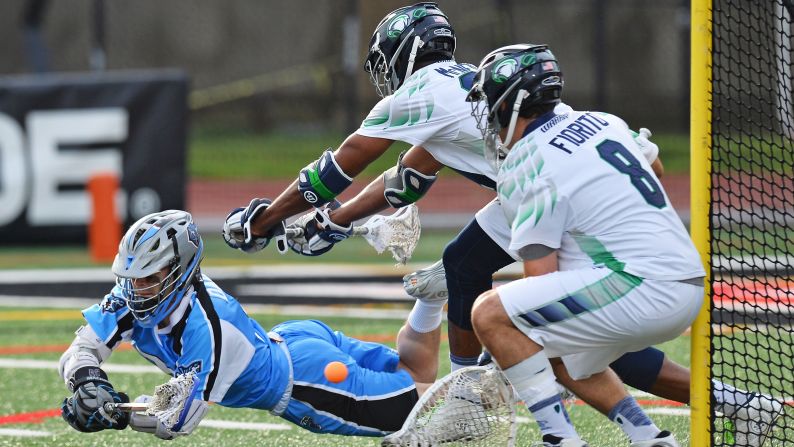 James Dailey of the Ohio Machine lays out to attempt a lacrosse shot as Chesapeake Bayhawks players Tyler Fiorito, No. 8, and Mark McNeill defend the goal on Saturday, June 20, at Selby Stadium in Delaware, Ohio.